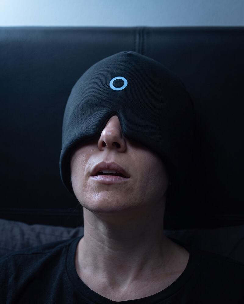 The DUSKHALO cap worn in a dark room, halo down over the eyes